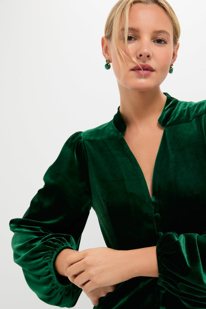 Person modeling the Green Velvet Serena Dress, featuring classic, long balloon sleeves and a fitted waist, exuding an effortless, high-end style perfect for fun, celebratory occasions.