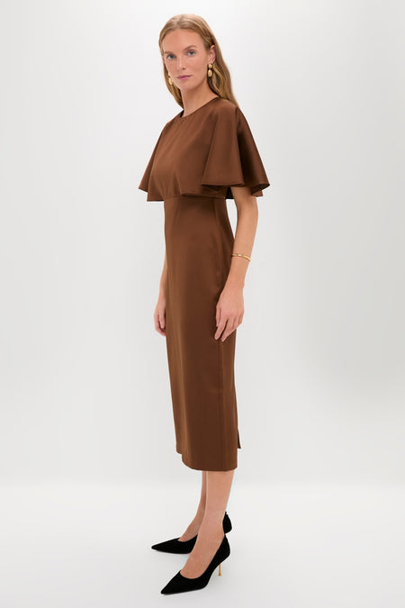 Model wearing the Chocolate Brown Cape Leah Dress, featuring classic cape-style sleeves and paired with black stiletto pumps and gold accessories, embodying effortless high-end style.