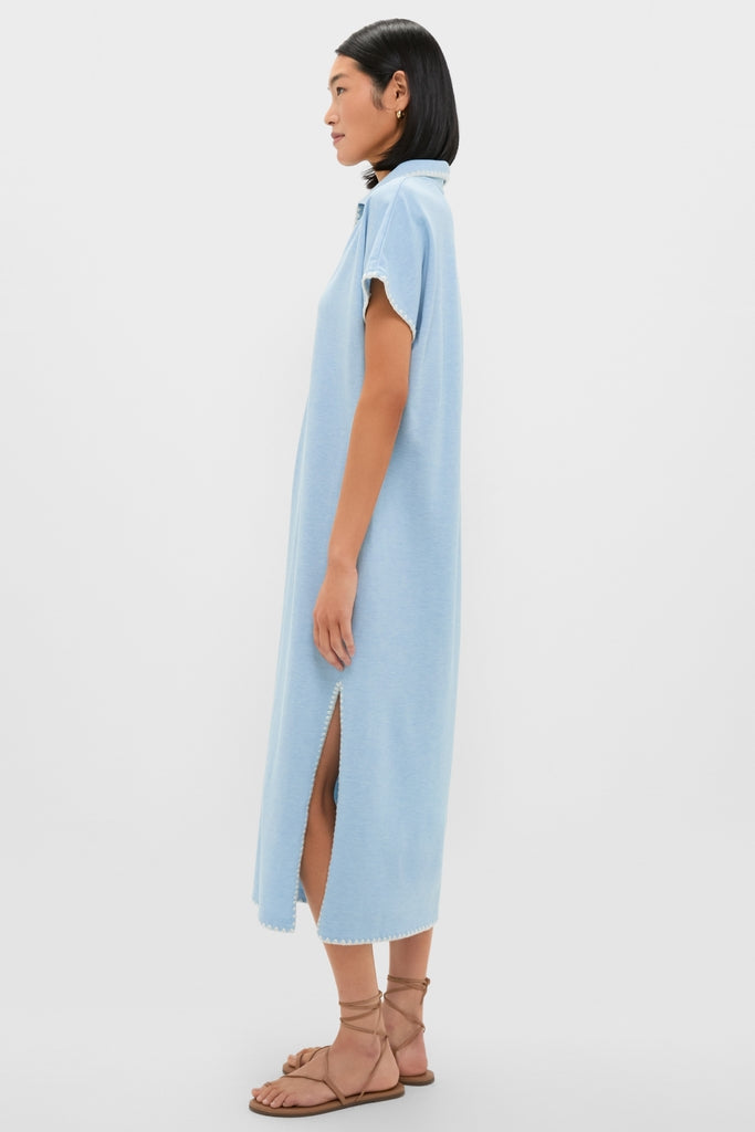 Model in Heather Chambray Pique Melissa Maxi Dress, showcasing classic, effortless style with a collared V-neckline, side slit, and whipstitch detailing, paired with tan sandals.