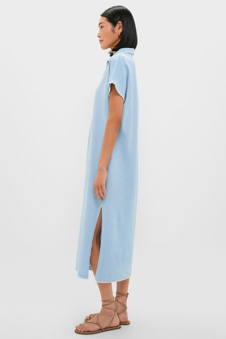 Model in Heather Chambray Pique Melissa Maxi Dress, showcasing classic, effortless style with a collared V-neckline, side slit, and whipstitch detailing, paired with tan sandals.