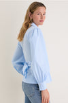 French Blue Tie Front Bow Bea Blouse exudes classic elegance with its effortless wrap design, voluminous sleeves, and chic bow detail, perfect for a high-end, fun style.