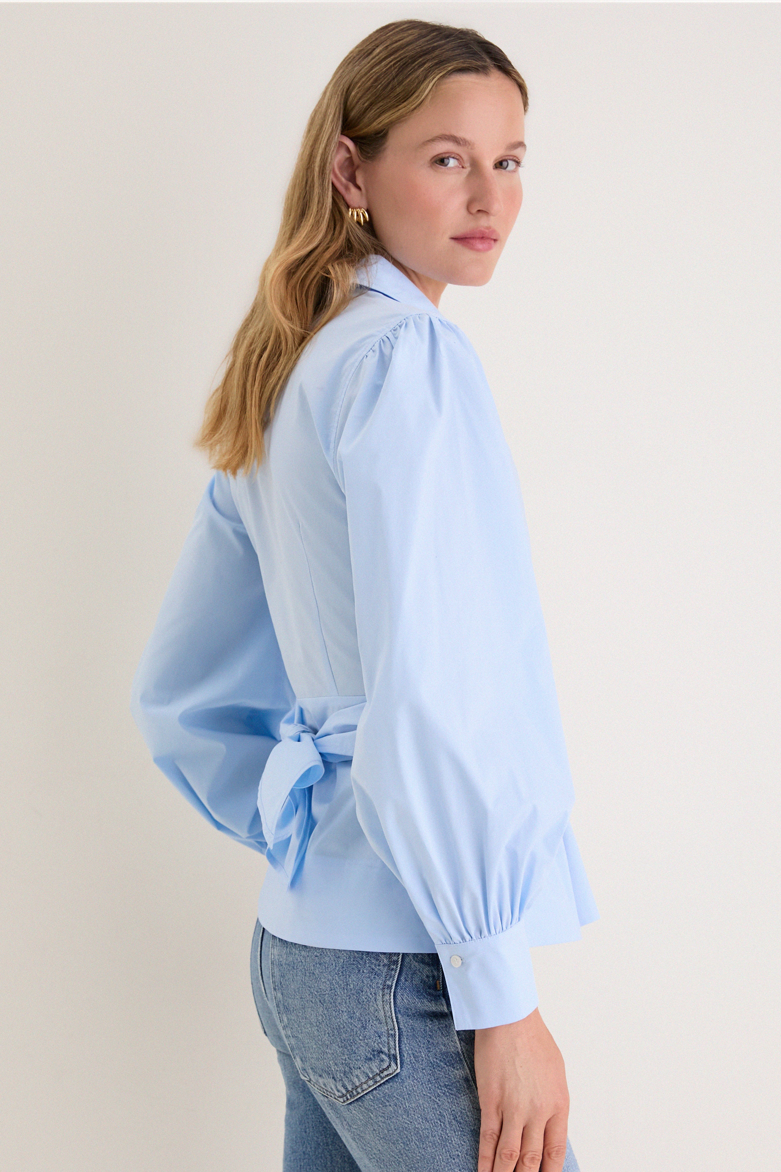 French Blue Tie Front Bow Bea Blouse exudes classic elegance with its effortless wrap design, voluminous sleeves, and chic bow detail, perfect for a high-end, fun style.