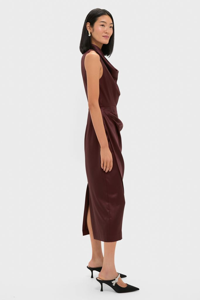 Woman in classic Chocolate Satin Sinclair Dress with cowl neck, side slit, and jeweled mule heels, embodying effortless, high-end style for fun holiday events.