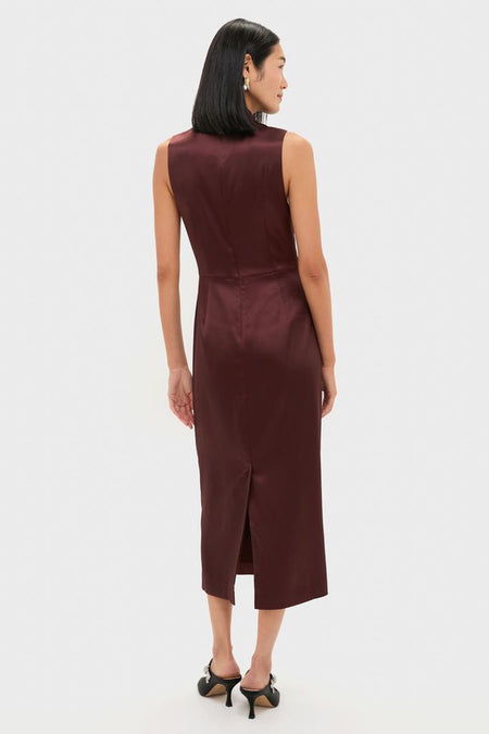 Rear view of a model in the classic Chocolate Satin Sinclair Dress, showcasing a sleek, effortless silhouette with heels, embodying high-end fun and sophistication.