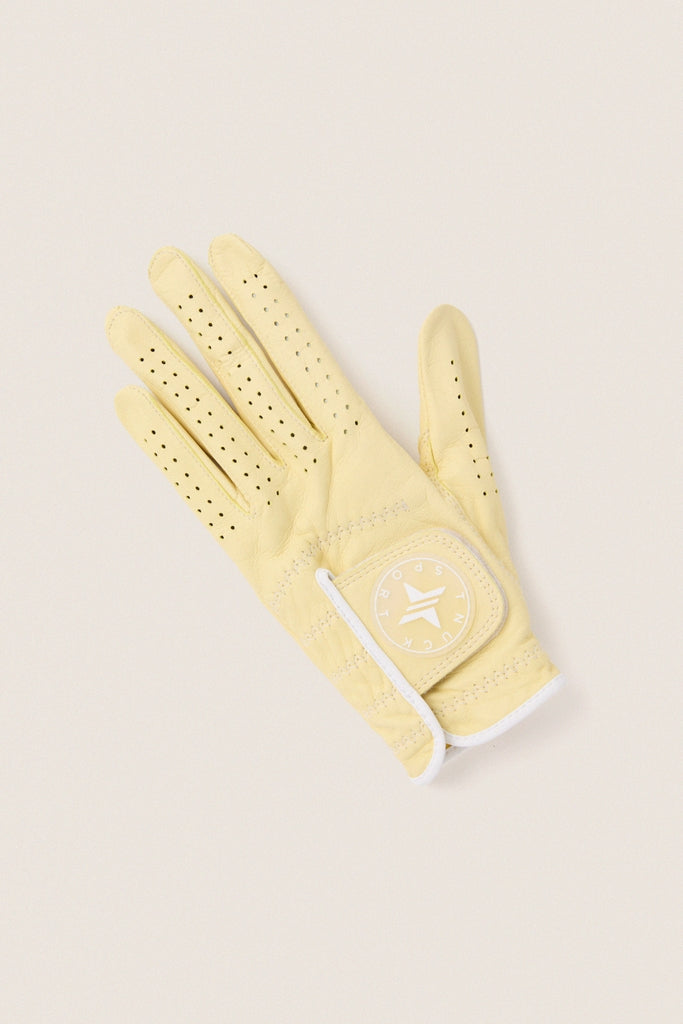 Yellow Left Hand Golf Glove: A classic, high-end pale-yellow leather glove with perforations and Velcro strap, offering effortless comfort and fun for an elevated golfing experience.