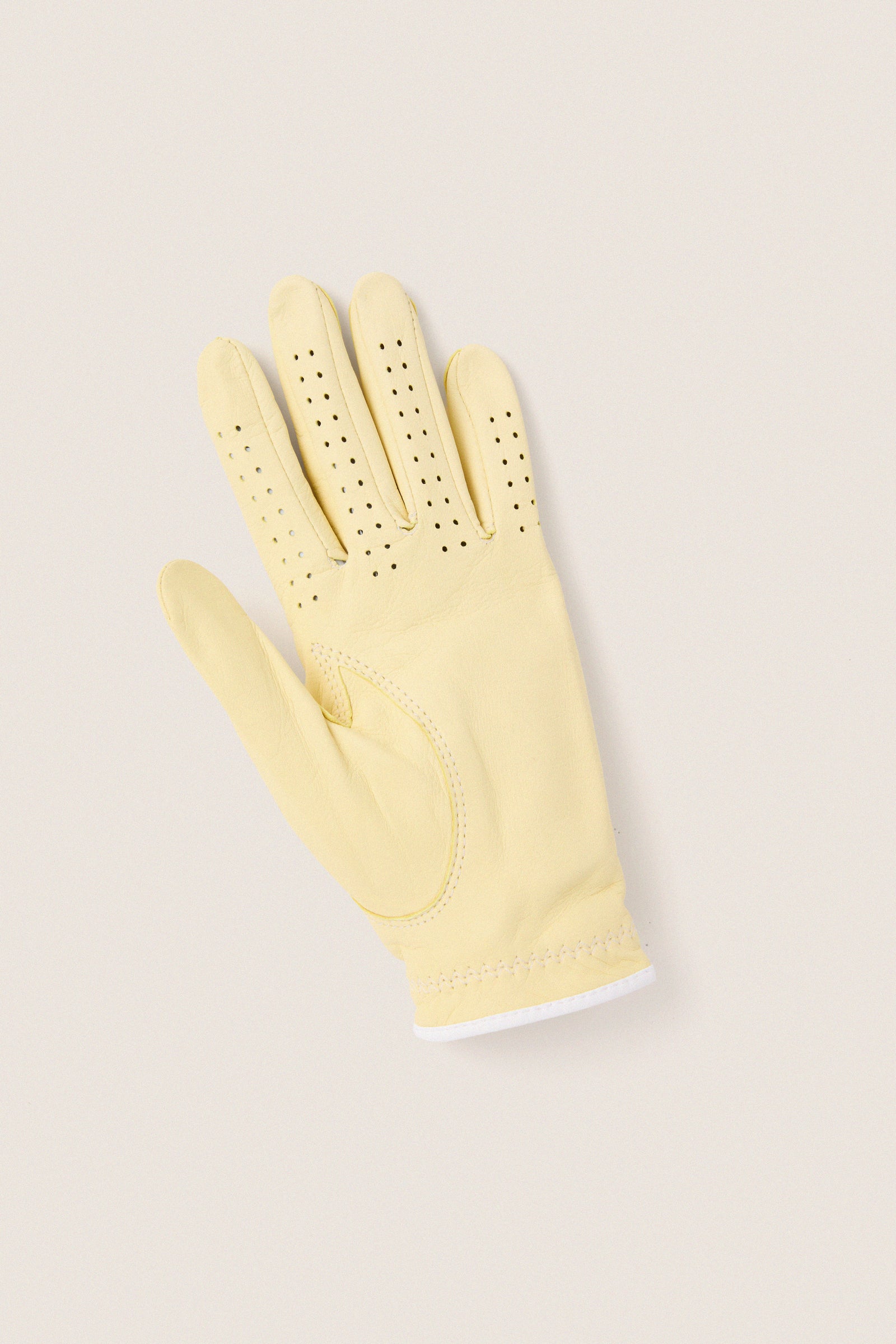 Yellow Left Hand Golf Glove with classic perforations and reinforced stitching, offering effortless comfort and a fun, high-end look for an enjoyable golfing experience.