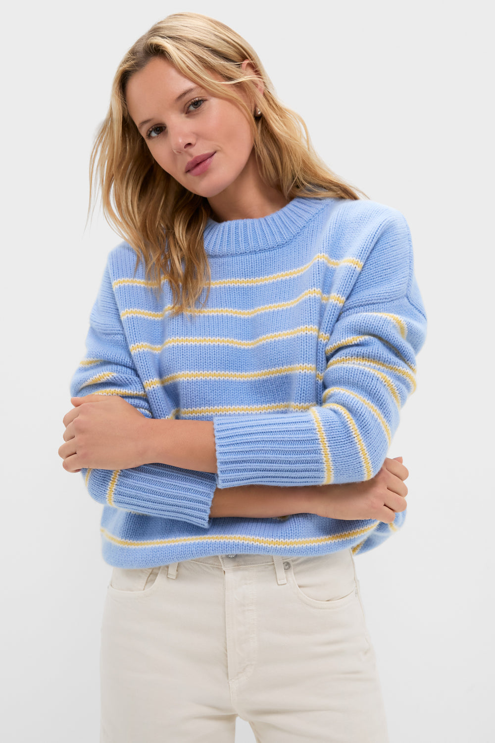 Model in a classic, high-end Chambray, Butter and Cream Fineline Stripe Marin Sweater, embodying effortless style with fun, relaxed fit and chunky knit texture.