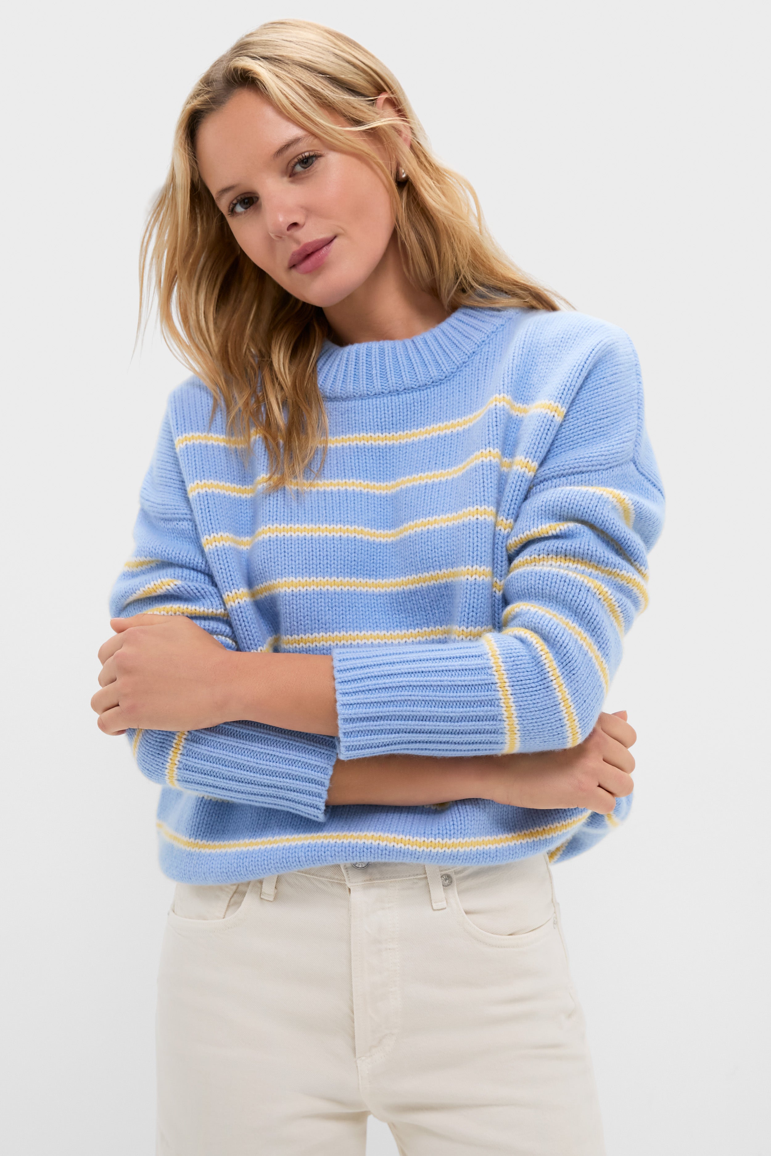 Model in a classic, high-end Chambray, Butter and Cream Fineline Stripe Marin Sweater, embodying effortless style with fun, relaxed fit and chunky knit texture.