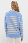 Person wearing the Chambray, Butter and Cream Fineline Stripe Marin Sweater, a classic, chunky knit with effortless style and fun stripes, paired with cream pants.