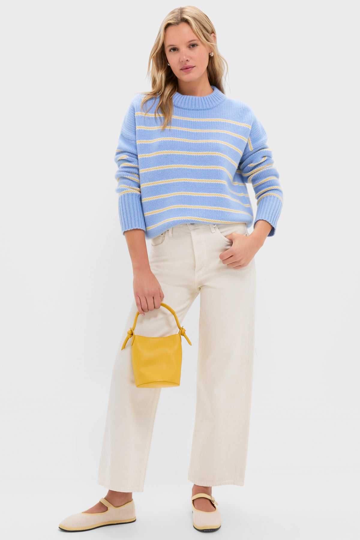 Young woman models the Chambray, Butter and Cream Fineline Stripe Marin Sweater, styled with wide-leg pants and Mary Jane flats for a classic, effortless, high-end look.