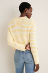 Person wearing the Sunshine and Cream Fine Stripe Mini Marina Sweater, showcasing its classic roll-neck and slim sleeves for an effortless, high-end look paired with light-wash jeans.