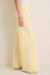 Model showcasing classic, high-end Butter Crepe Colby Pant with effortless wide-leg design, elastic waistband, and matching heels, epitomizing fun, elevated style.