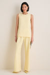 Model wearing classic Butter Crepe Colby Pant with a straight-leg and elastic waistband, paired with matching top and heels, showcasing an effortless, high-end style.