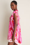 Young woman in profile wearing the Pink Holy Snake Mini Sasha Dress, showcasing a classic, effortless boho chic style with floral print and lace hem.