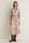 Woman models the Soft Tan Western Embroidered Herd Dress, a classic, high-end shirtdress with floral embroidery and balloon sleeves, styled effortlessly with fun cowboy boots.