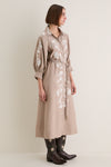 Woman in profile wearing a classic Soft Tan Western Embroidered Herd Dress with floral embroidery, puffed sleeves, and cowboy boots, embodying effortless, high-end style.