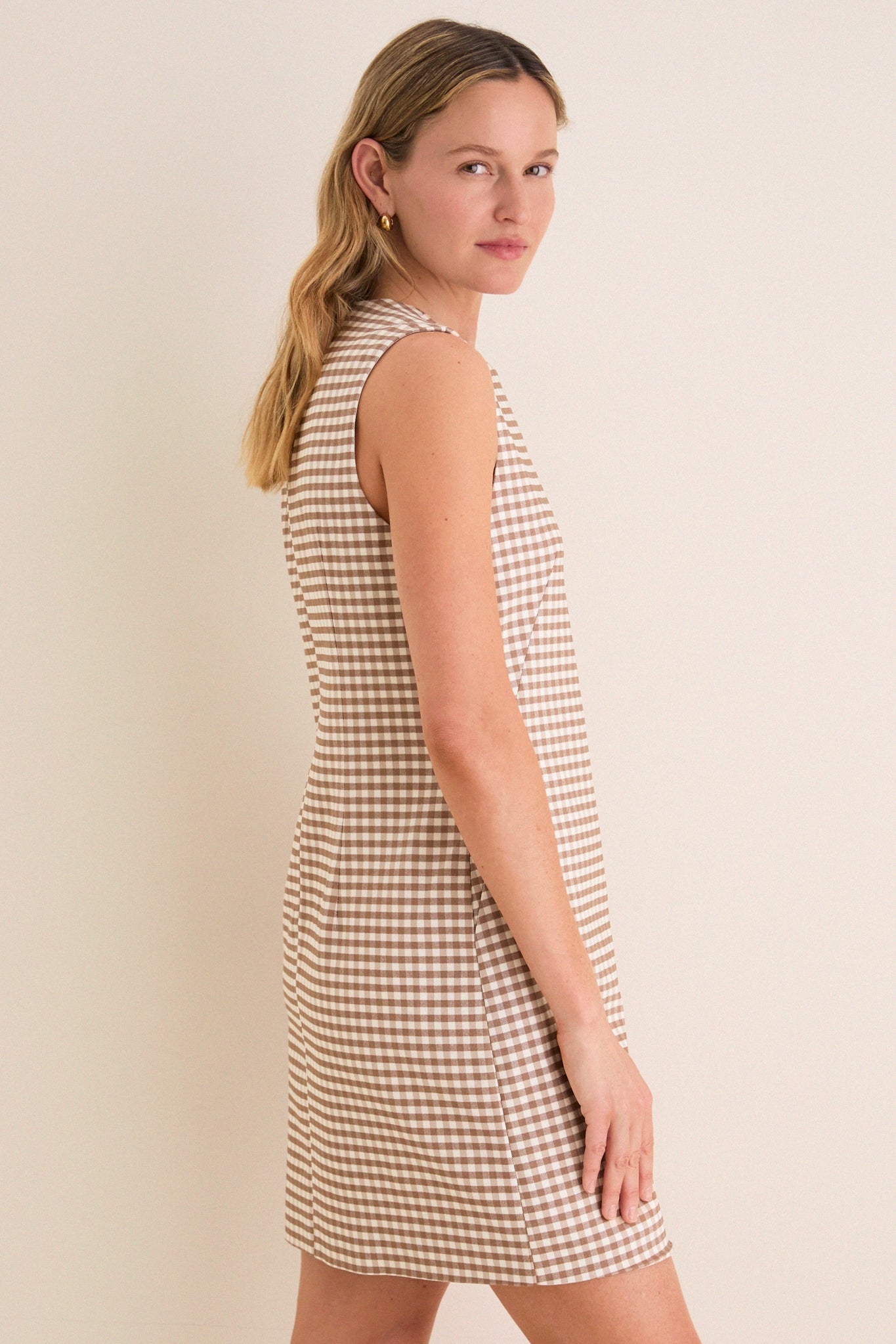 Mocha Gingham Yvette Mini Dress: A classic, effortless sleeveless dress with a crew neckline and mini length, ideal for fun, high-end day-to-night styling.