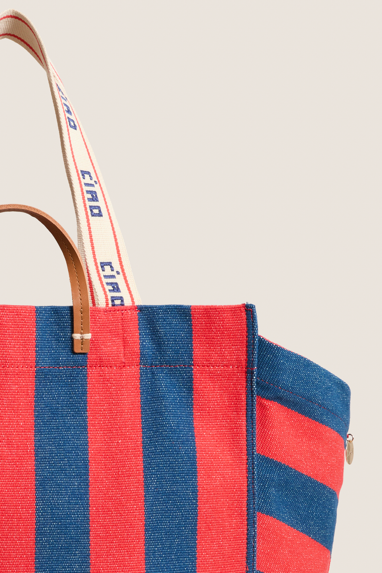 Classic Poppy and French Blue Beach Tote with bold stripes and ciao strap, offering effortless style and fun versatility for high-end, everyday use.