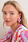 Young woman with blonde hair wearing classic, fun Cotton Candy and Gold Cumulus Earrings, featuring chunky gold hoops and pink elements, showcasing an effortless, high-end style.