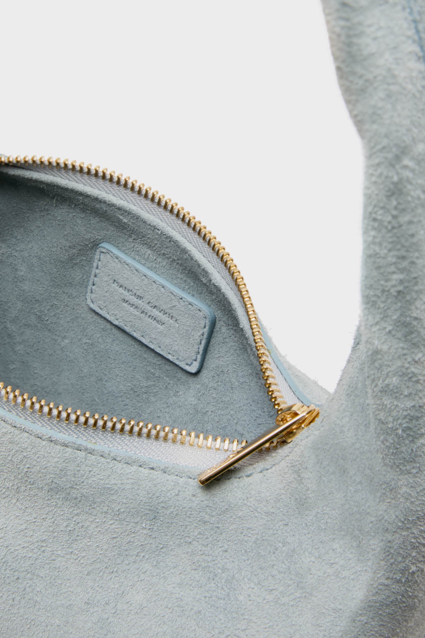 Classic Baby Blue Gnocchi Bag in suede with a gold zipper, showcasing effortless and high-end style. Perfect for a fun, versatile, and polished everyday look.