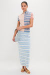 Young woman showcases the classic Baby Blue Gnocchi Bag, an effortless, high-end suede accessory, paired with a fun, striped outfit for a stylish, polished look.