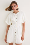Model in a classic, effortless Bastille Short Dress with puffed sleeves and button placket, embodying a high-end, fun aesthetic perfect for versatile, leisurely weekends.