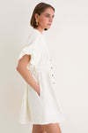 Young woman in profile wearing the classic, high-end Star White Bastille Short Dress with an effortless, feminine silhouette, perfect for fun, slow weekends.
