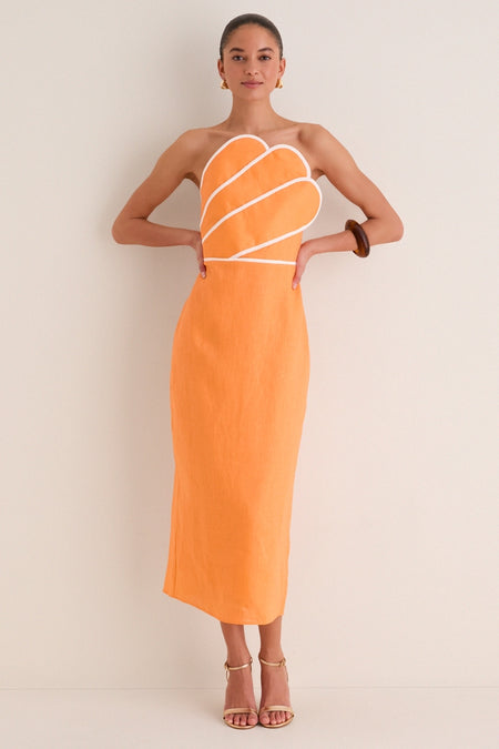 Model in a classic, strapless Orange Linen Clementine Maxi Dress with contrast piping and scallop overlay, styled with gold accessories for an effortless, high-end look.