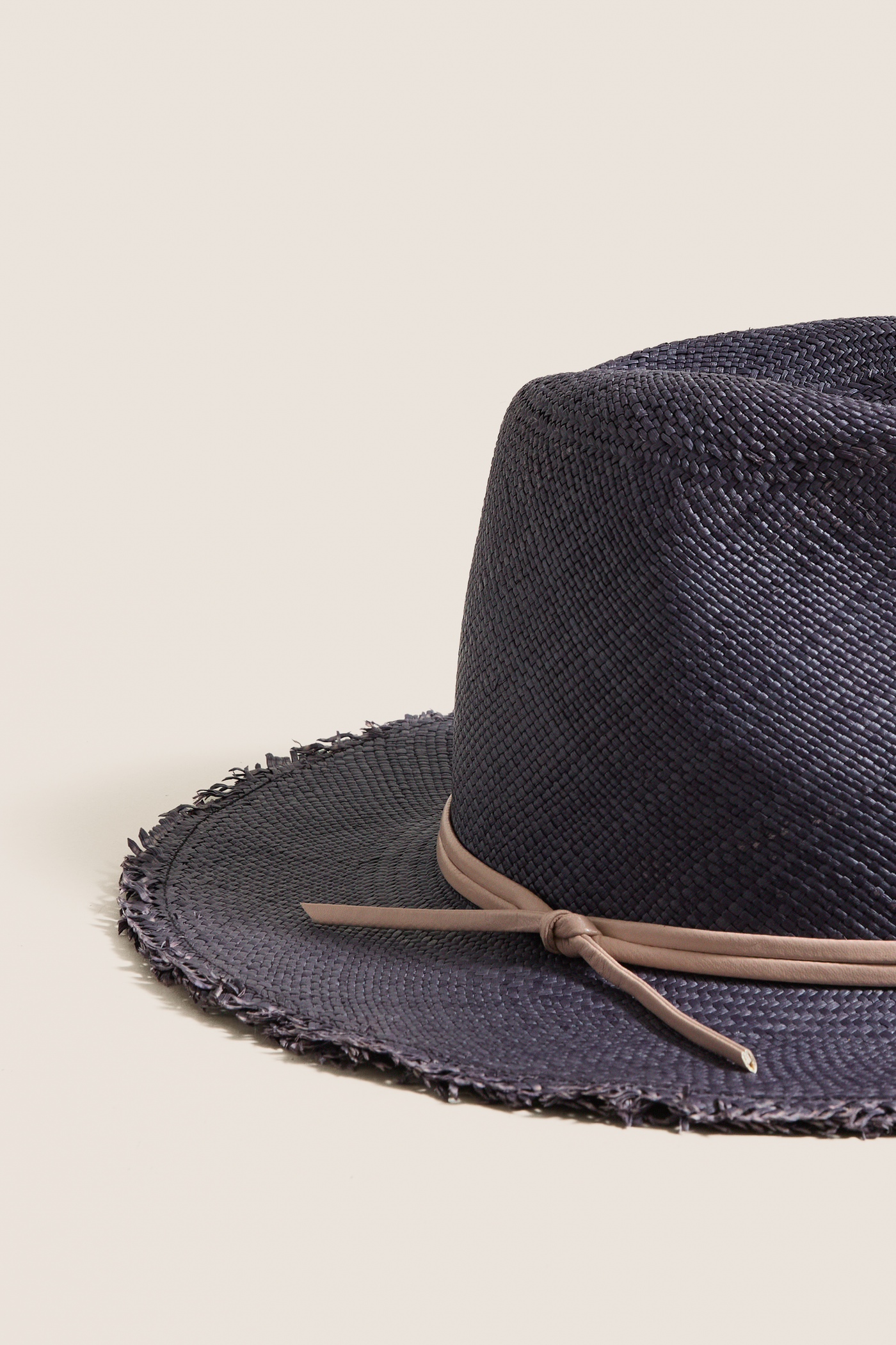 Navy and Tan Fringed Pammy Panama Continental Hat: A classic, effortless straw hat with a fun fringe brim and high-end leather band, perfect for sun-filled adventures.