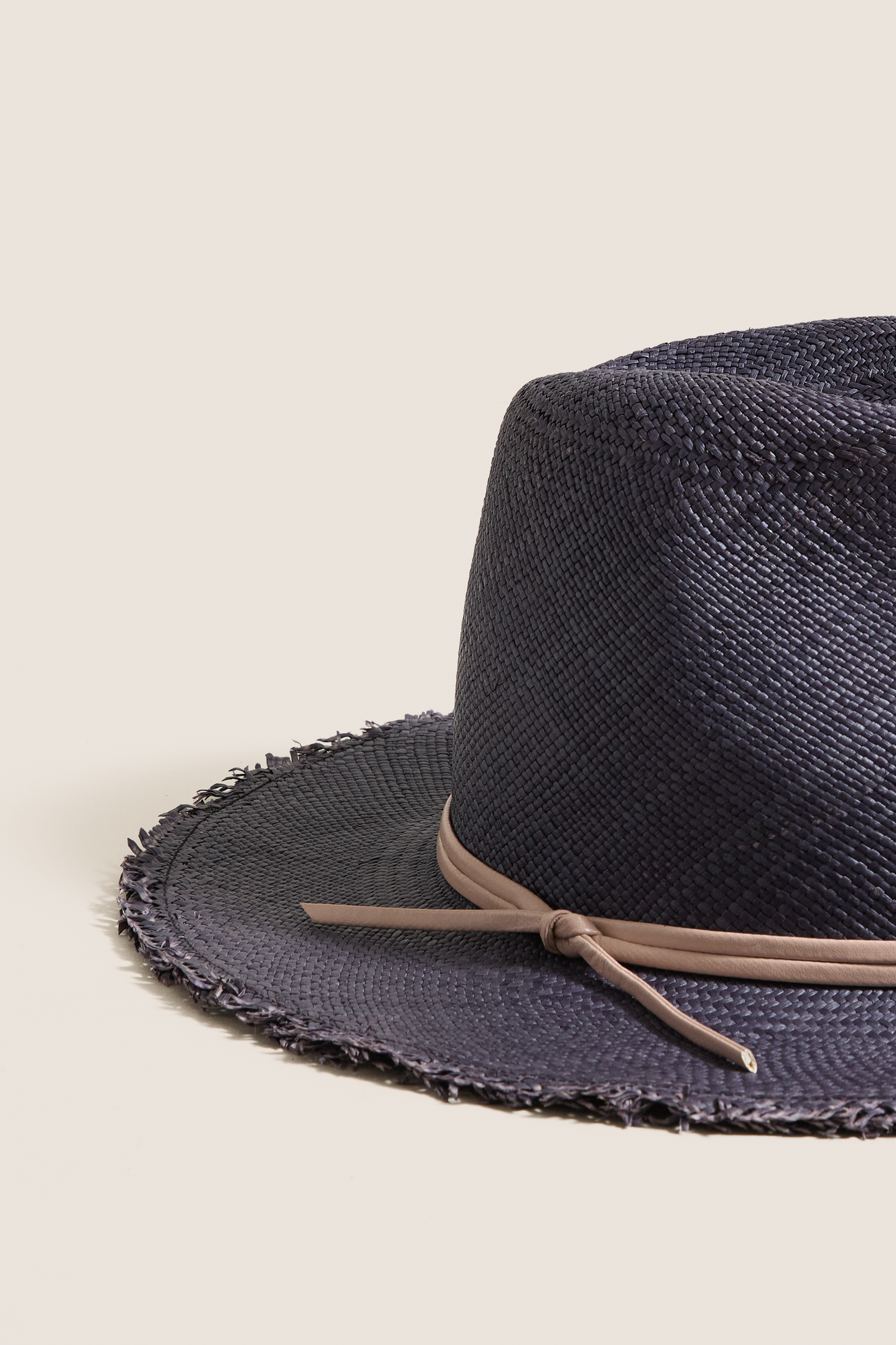 Navy and Tan Fringed Pammy Panama Continental Hat: A classic, effortless straw hat with a fun fringe brim and high-end leather band, perfect for sun-filled adventures.