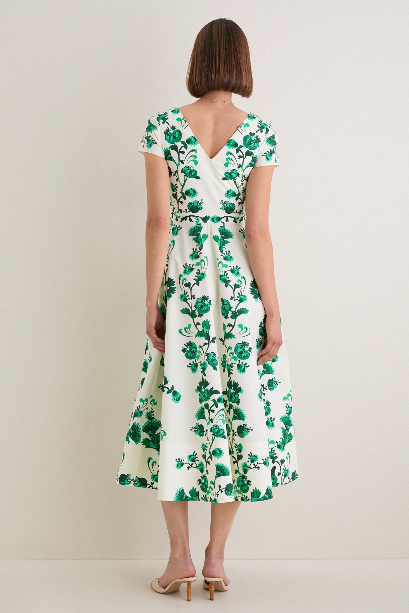 Saffier Vines Zoey-E Midi Dress: A classic, effortless A-line dress with a bold green floral motif, V-back, and patch pockets, perfect for a fun, high-end look.