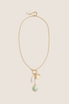 Gold Multi Frances Charm Necklace features a classic gold-tone chain with charms including a pearl drop, gold medallion, bar pendant, and mint-green palm-tree charm, offering effortless, high-end elegance.