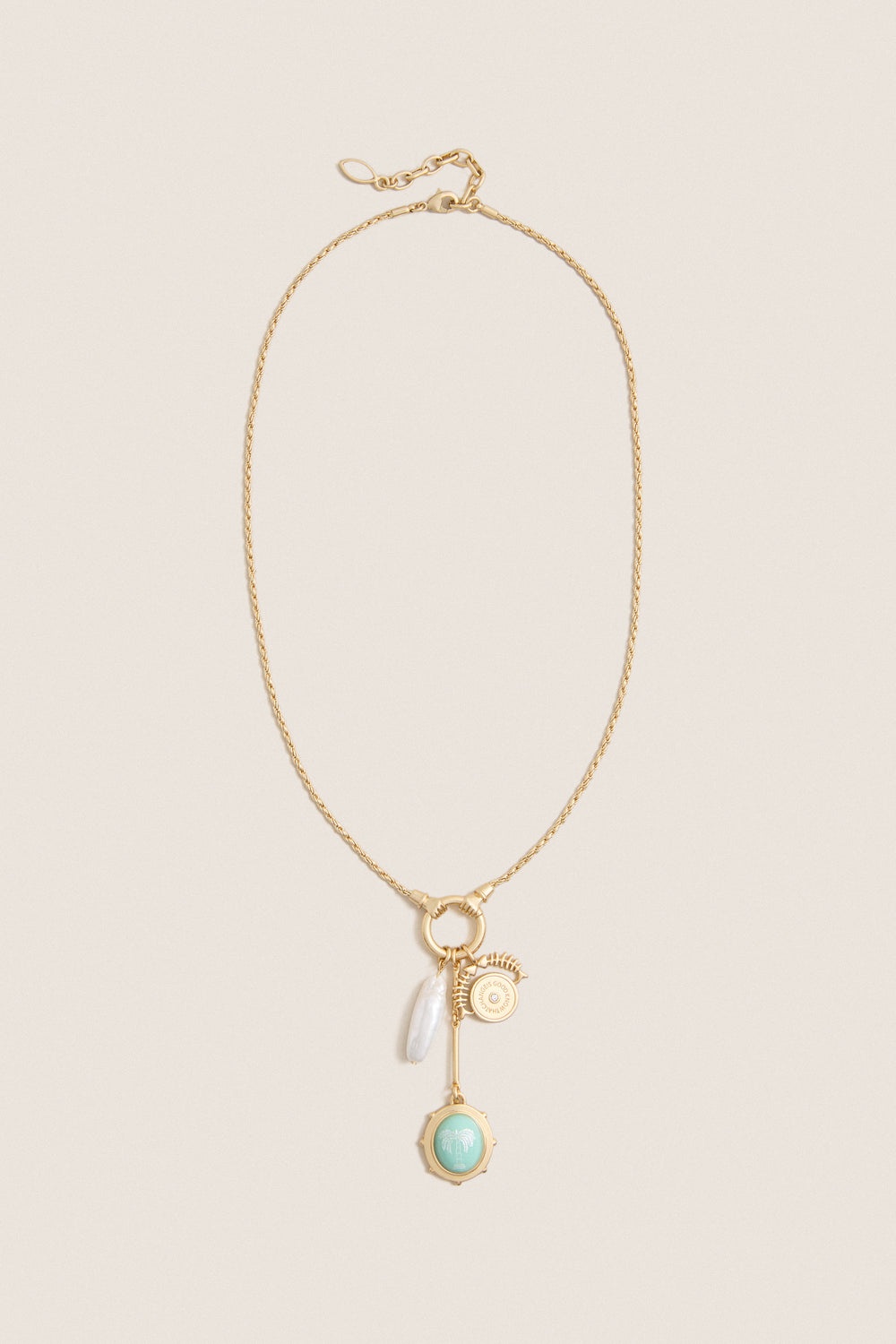 Gold Multi Frances Charm Necklace features a classic gold-tone chain with charms including a pearl drop, gold medallion, bar pendant, and mint-green palm-tree charm, offering effortless, high-end elegance.