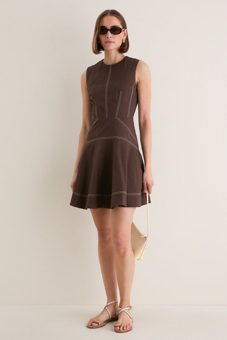 Young woman models the Dark Mocha Mini Karrigan Dress, showcasing its classic fit-and-flare silhouette, fun contrast topstitching, and effortless high-end style.