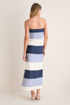 Woman in a strapless, floor-length Blue Stripes Sono Maxi Dress, showcasing classic, effortless elegance with a fitted silhouette and side slit. Perfect for high-end, fun summer occasions.