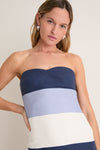 Young woman models the Blue Stripes Sono Maxi Dress, showcasing its classic, effortless silhouette with nautical blue stripes, perfect for fun, high-end summer occasions.