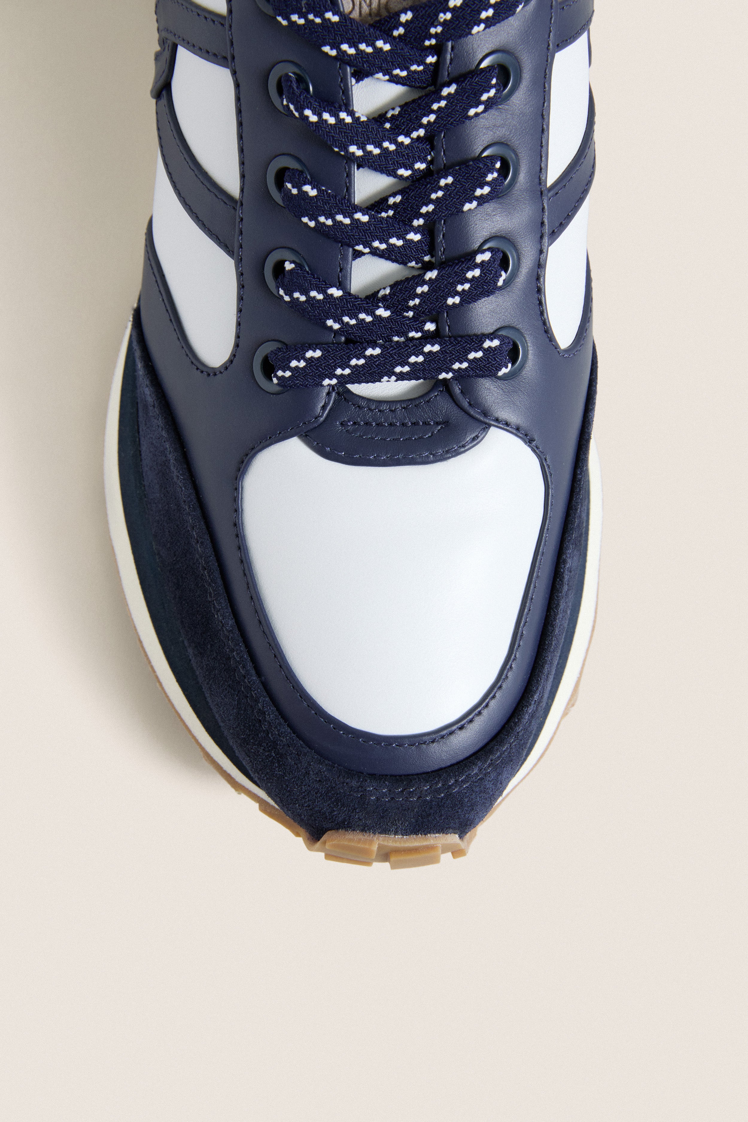 Navy Multi Valentina Sneakers featuring a classic white leather upper, navy suede toe, and effortless patterned laces. A fun, high-end everyday shoe.