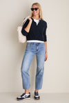 Young woman in classic, effortless style wearing Navy Multi Valentina Sneakers. The sneakers feature a chic, two-tone design with suede detailing, embodying high-end comfort and fun.