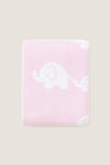 Pink Elephant Knit Blanket, featuring classic white elephant silhouettes on soft pink. Made from high-end, ultra-soft cotton for effortless comfort and fun snuggles.