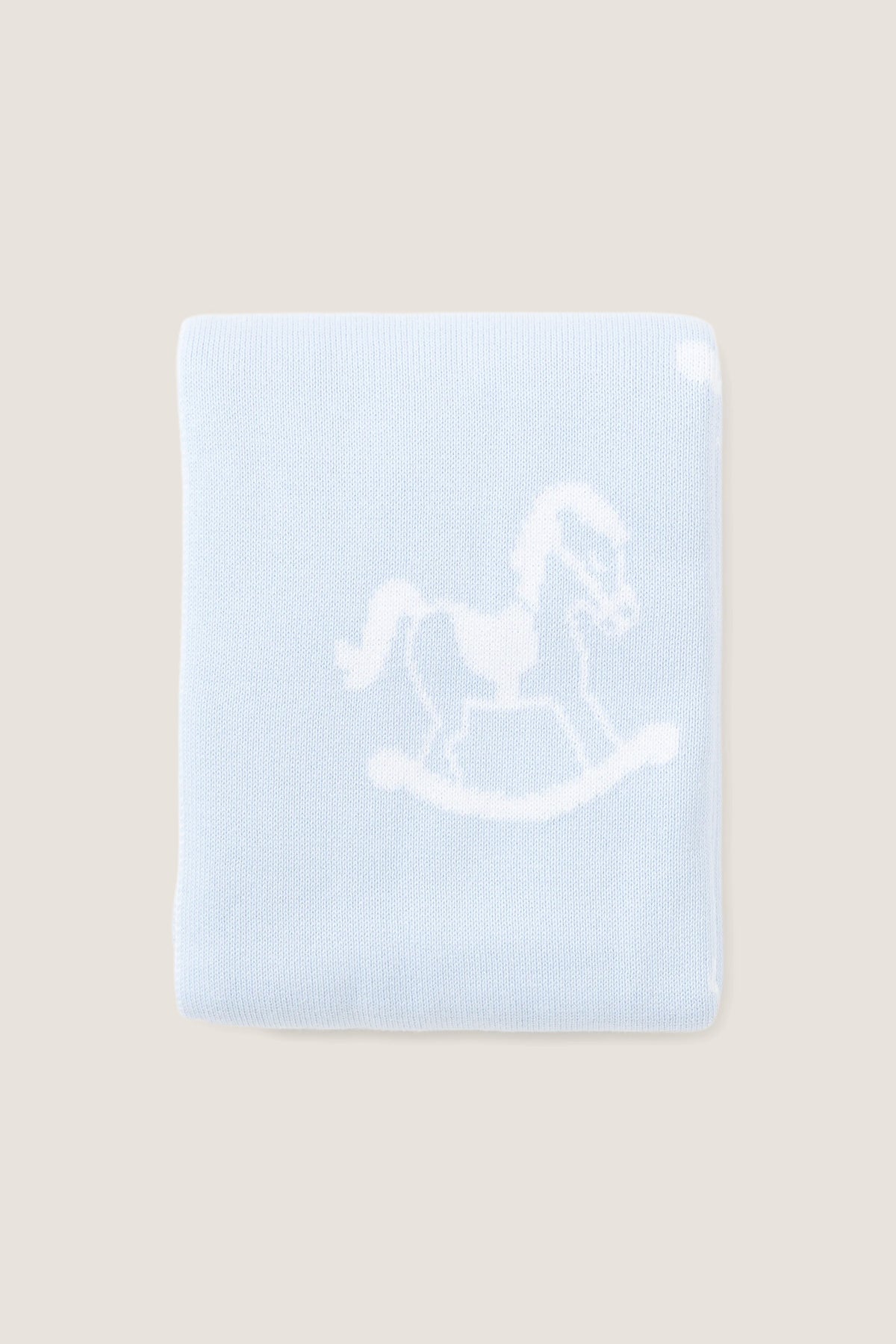 Blue Rocker Knit Blanket with classic rocking horse motif, crafted from ultra-soft cotton for an effortless and fun nursery touch. Ideal for high-end comfort.