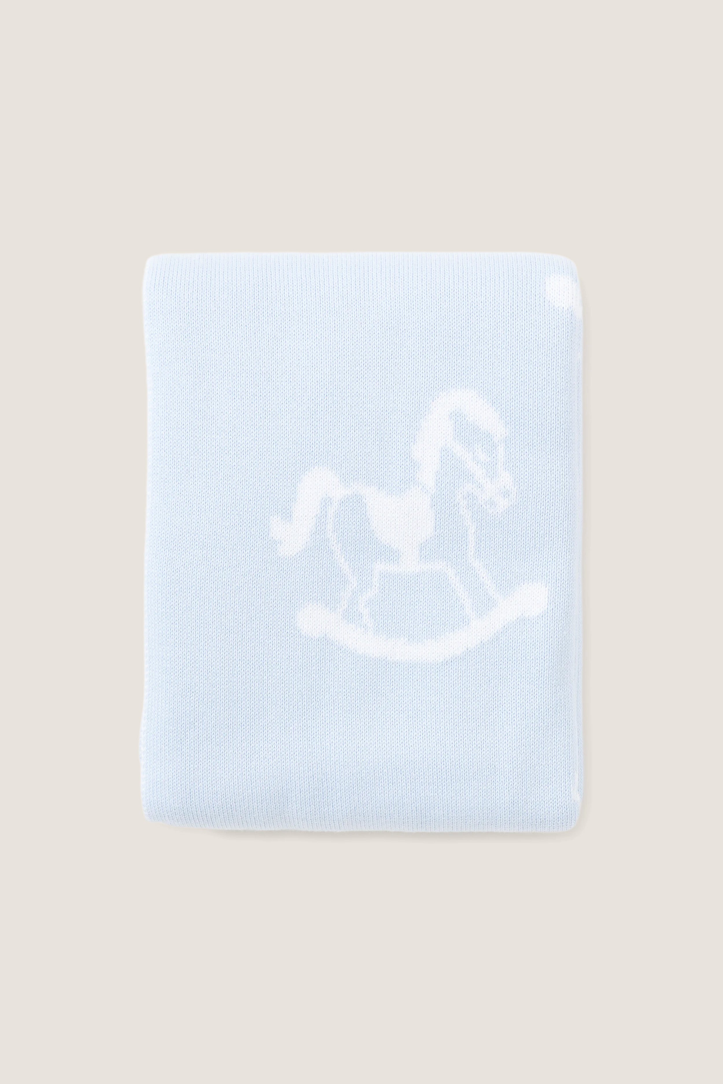 Blue Rocker Knit Blanket with classic rocking horse motif, crafted from ultra-soft cotton for an effortless and fun nursery touch. Ideal for high-end comfort.