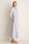 Young woman in profile wearing the Arbor Blue Maxi Shirt Dress; a classic, high-end cotton voile piece with an effortless floral print and gold accents.