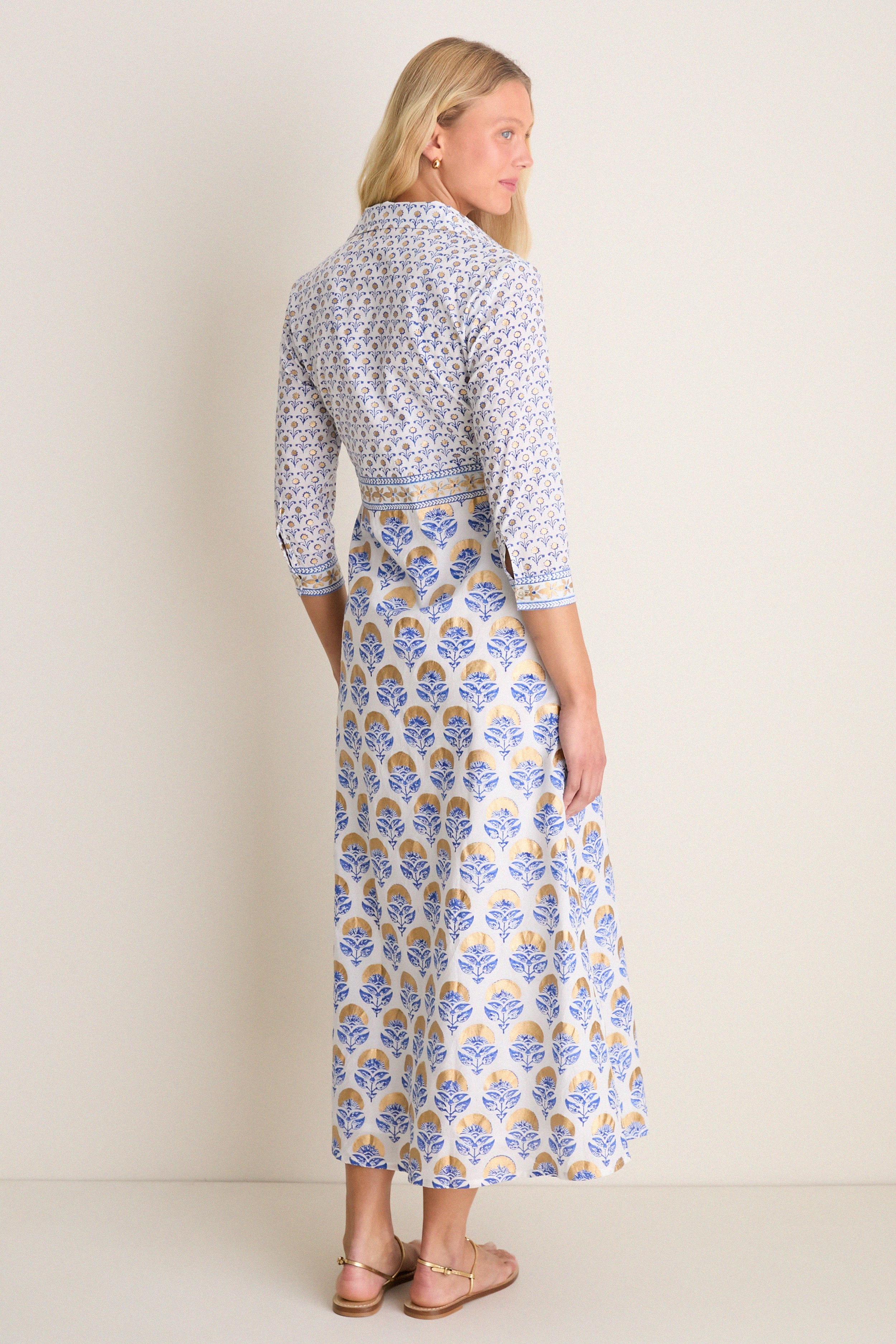 Arbor Blue Maxi Shirt Dress: A classic, effortless wrap dress with a floral motif, perfect for high-end, fun occasions. Features three-quarter sleeves and metallic-gold sandals.