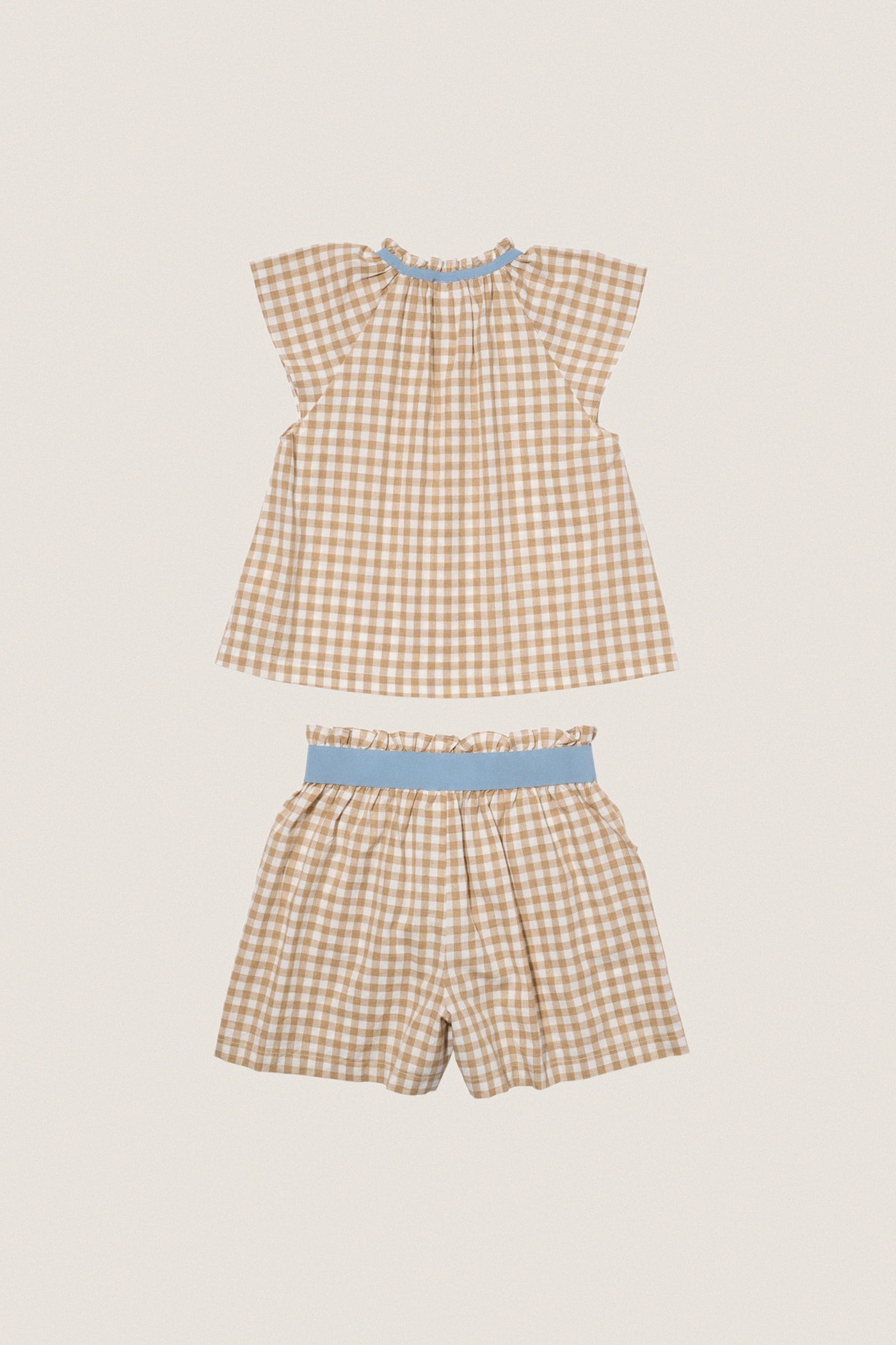 Camel Check Cecil Short Set, a classic gingham two-piece with effortless style. Features a ruffled blouse and elastic shorts, perfect for fun, high-end summer outings.