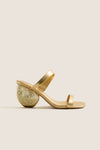 Gold Marion Metallic Shell Heels featuring classic, effortless design; minimalist two-strap upper with fun, high-end spiral shell-inspired sculpted heel, crafted in luxurious gold-tone leather.