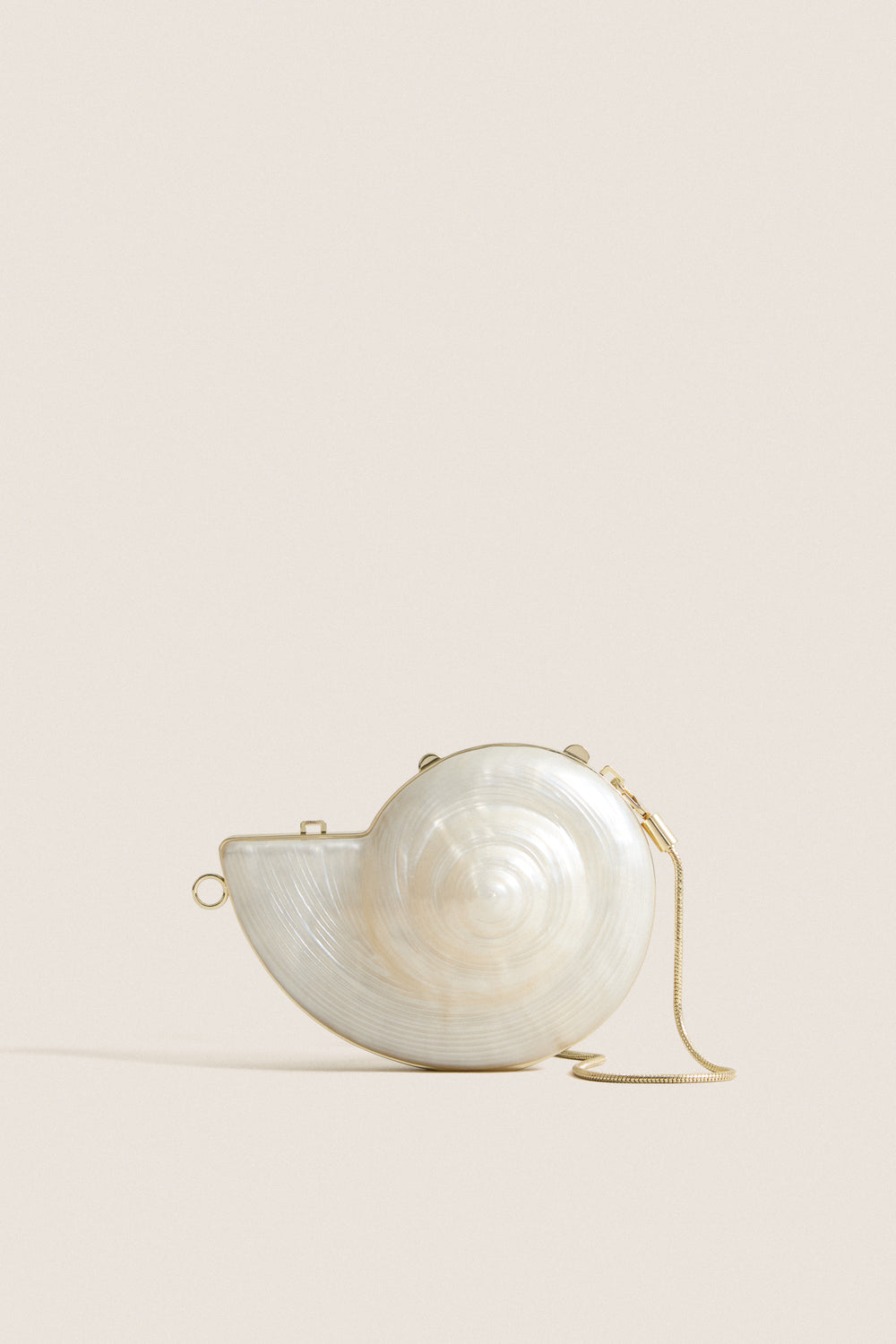 Pearl Marion Shell Clutch, a high-end, fun accessory with a nautilus shape, mother-of-pearl finish, gold trim, and chain, for an effortless, classic style.