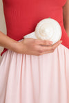 Pearl Marion Shell Clutch, a classic, spiral-shell accessory with a pearlescent finish, exudes effortless elegance and fun versatility, perfect for high-end, chic styling.