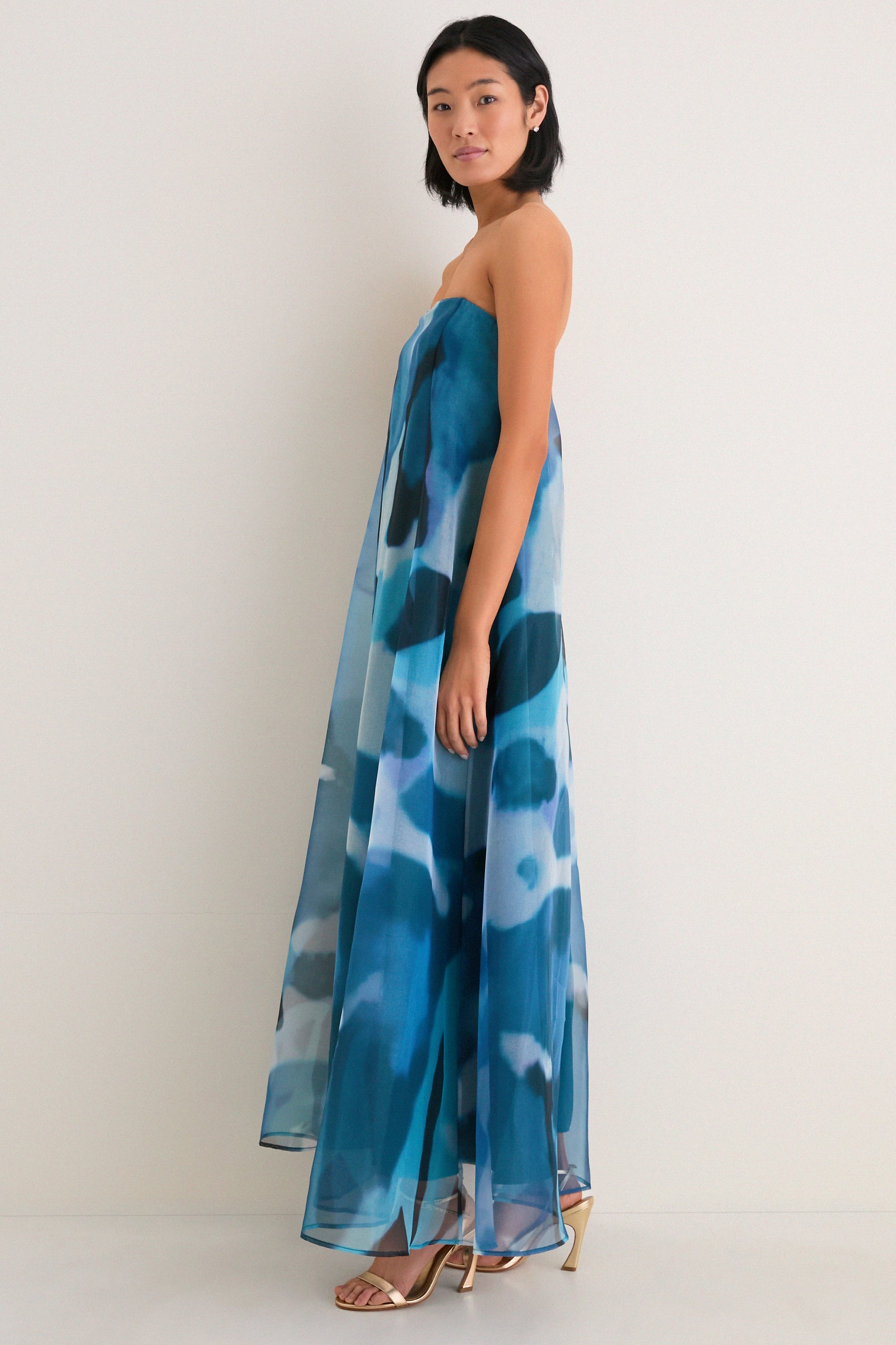 Blue Haze Allyson Dress: A classic, high-end strapless gown with effortless elegance, featuring a sheer overlay and internal corset. Perfectly paired with fun, metallic gold sandals.