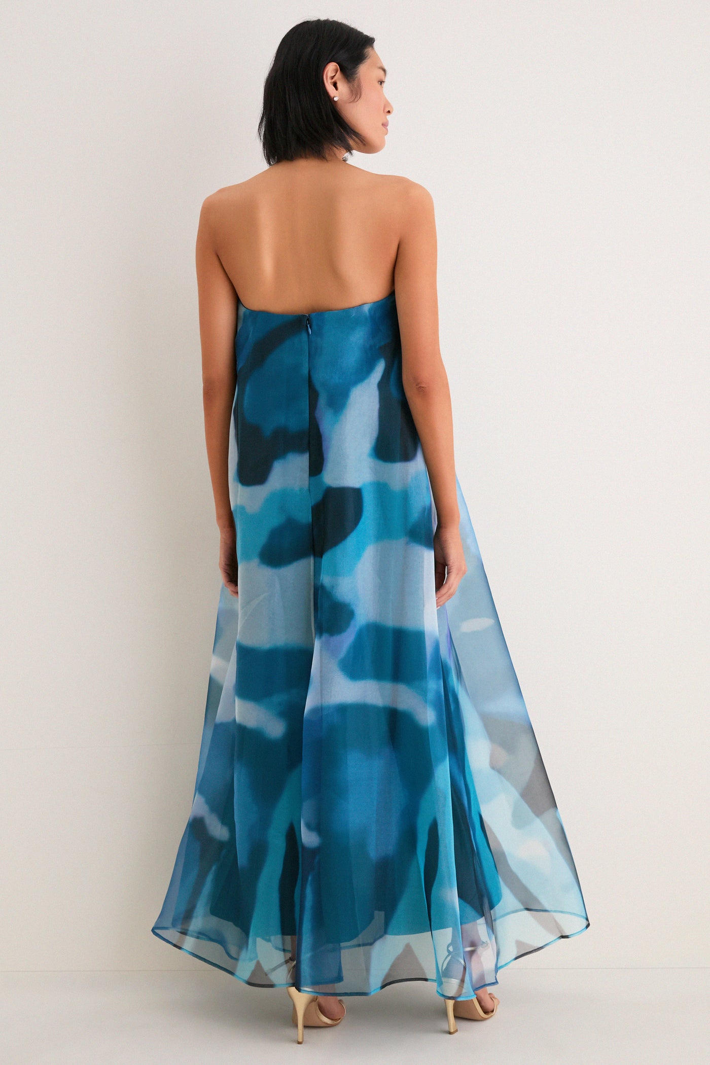 Woman in Blue Haze Allyson Dress: a classic, strapless maxi with effortless, high-end style, showcasing a watercolor pattern and elegant, flowing silhouette.
