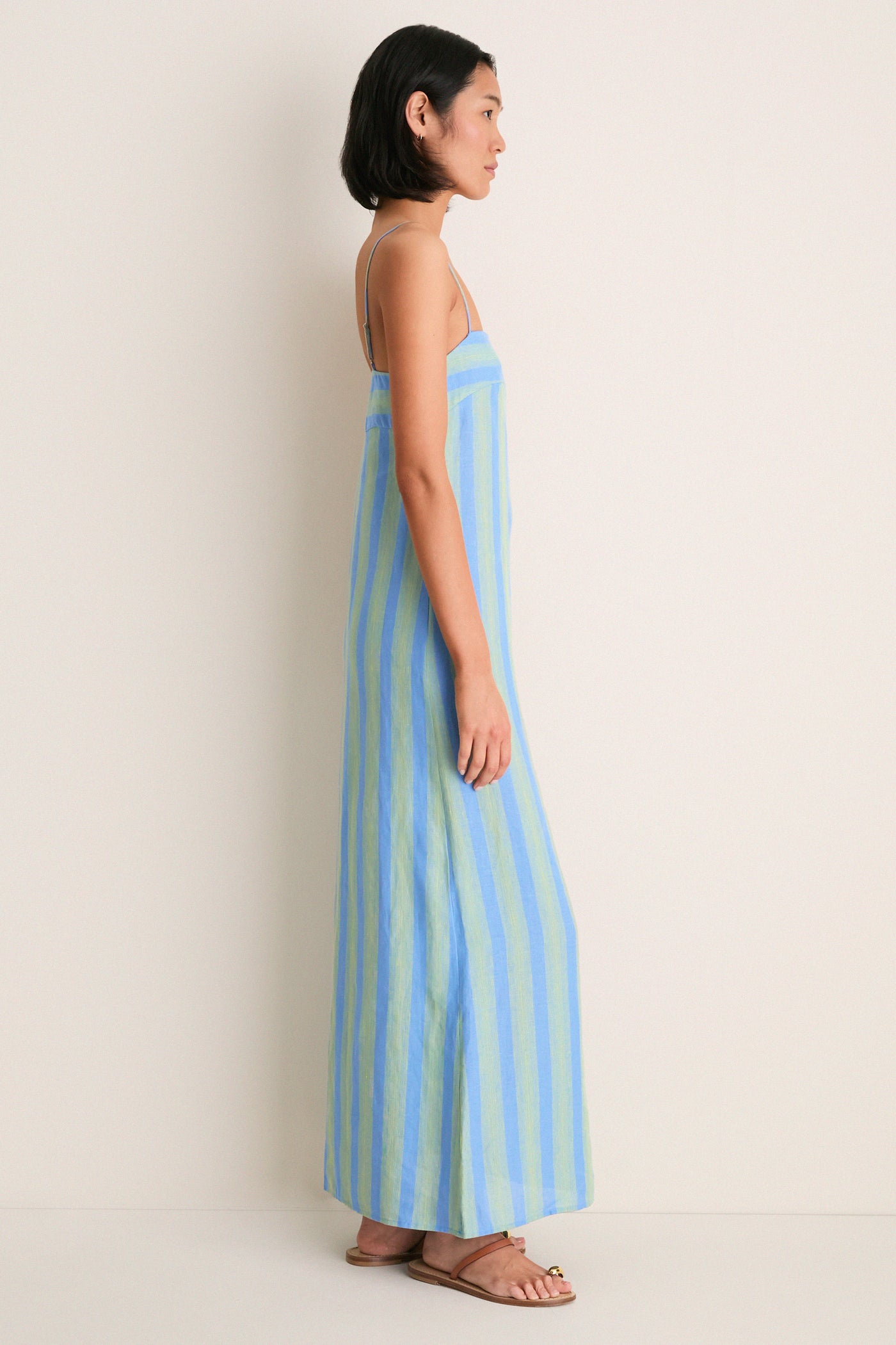 Seaport Stripe Laura Linen Dress: A classic, effortless floor-length sundress with pale blue and green stripes, square neckline, and adjustable spaghetti straps for a fun, high-end look.